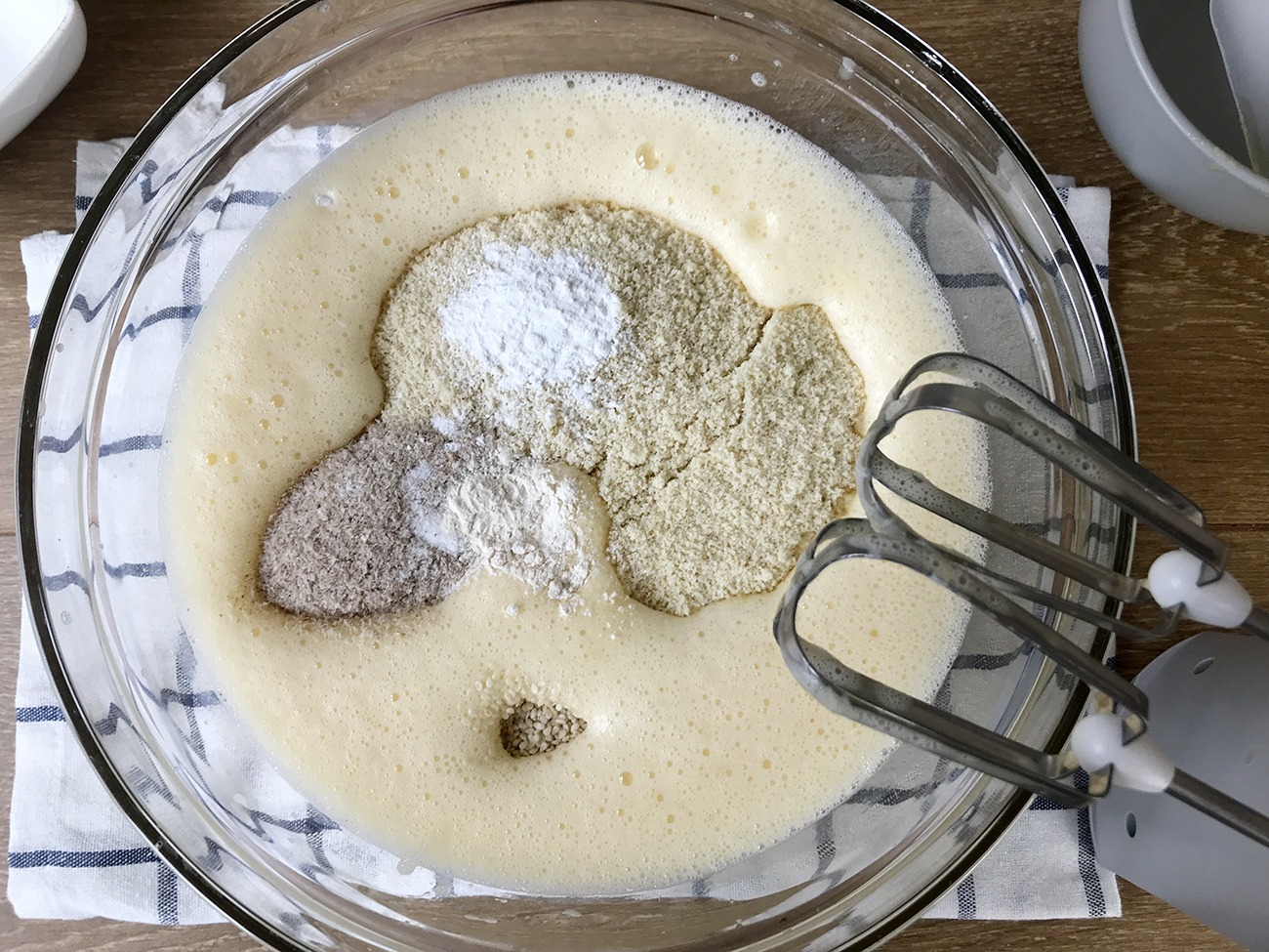 Mix in almond flour, salt, psyllium husk, coconut flour, sesame seeds, baking powder and xanthan gum.