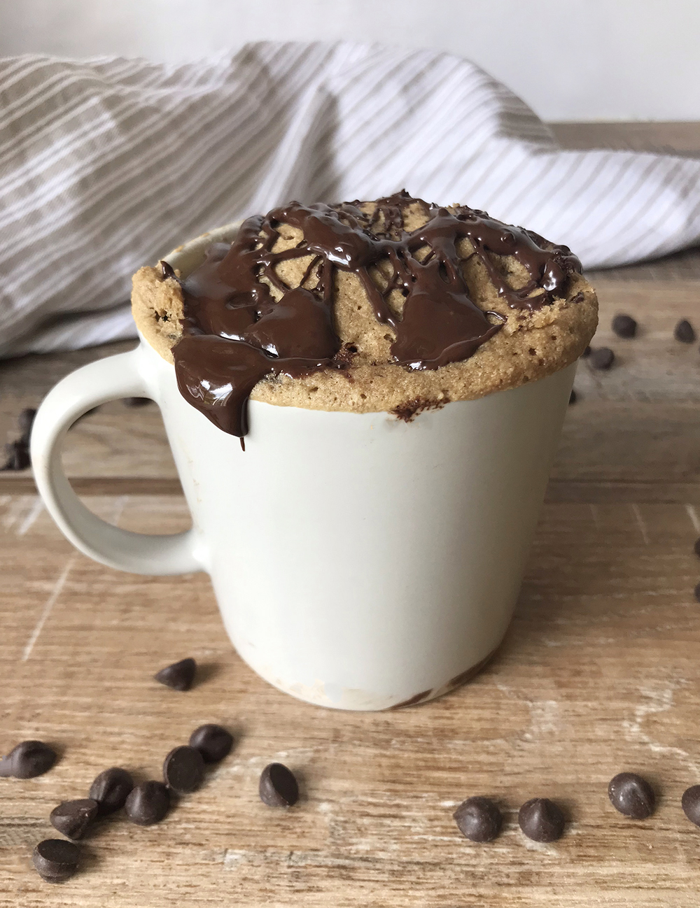 Keto Coffee Mug Cake with chocolate glaze on top.