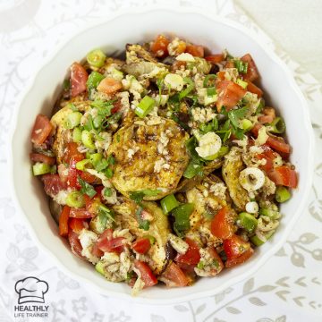 Mediterranean eggplant salad made with mixing baked or grilled eggplant, tomatoes, spring onion and drizzled with garlic, vinegar, olive oil.