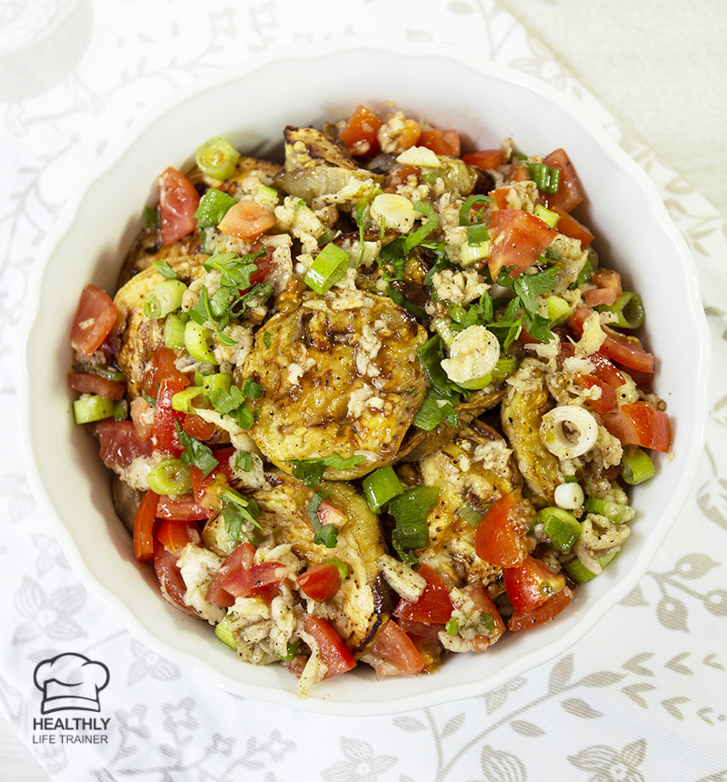 Mediterranean eggplant salad made with mixing baked or grilled eggplant, tomatoes, spring onion and drizzled with garlic, vinegar, olive oil.