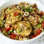 Mediterranean eggplant salad made with mixing baked or grilled eggplant, tomatoes, spring onion and drizzled with garlic, vinegar, olive oil.