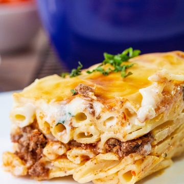 Baked pasta is layered with a well-seasoned beef mixture and topped with creamy bechamel sauce