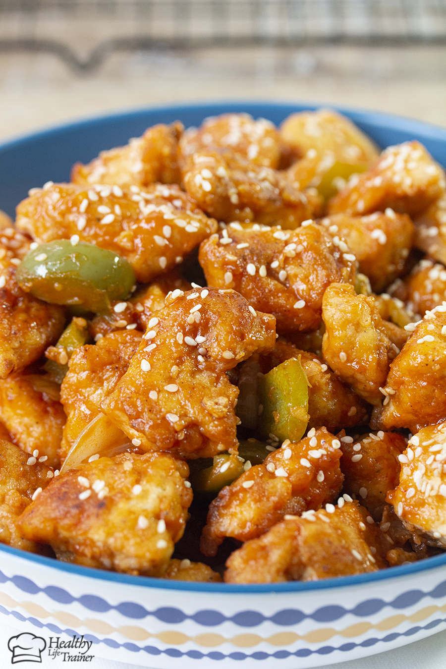 Chinese-style crispy sweet and sour chicken recipe is a crispy light fried chicken simmered in a well-balanced fragranced sticky sauce along with crunchy vegetable chunks.