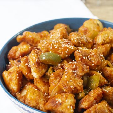 Chinese-style crispy sweet and sour chicken recipe is a crispy light fried chicken simmered in a well-balanced fragranced sticky sauce along with crunchy vegetable chunks.