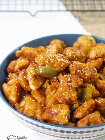 Chinese-style crispy sweet and sour chicken recipe is a crispy light fried chicken simmered in a well-balanced fragranced sticky sauce along with crunchy vegetable chunks.