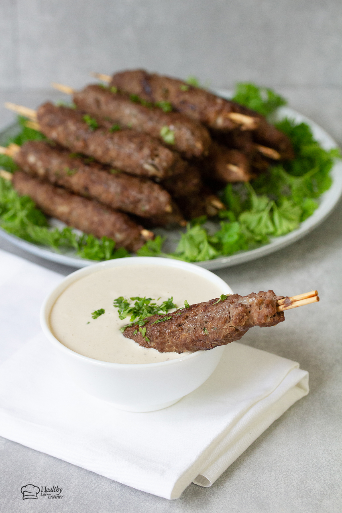 Kofta Kebab dipped in tahini sauce