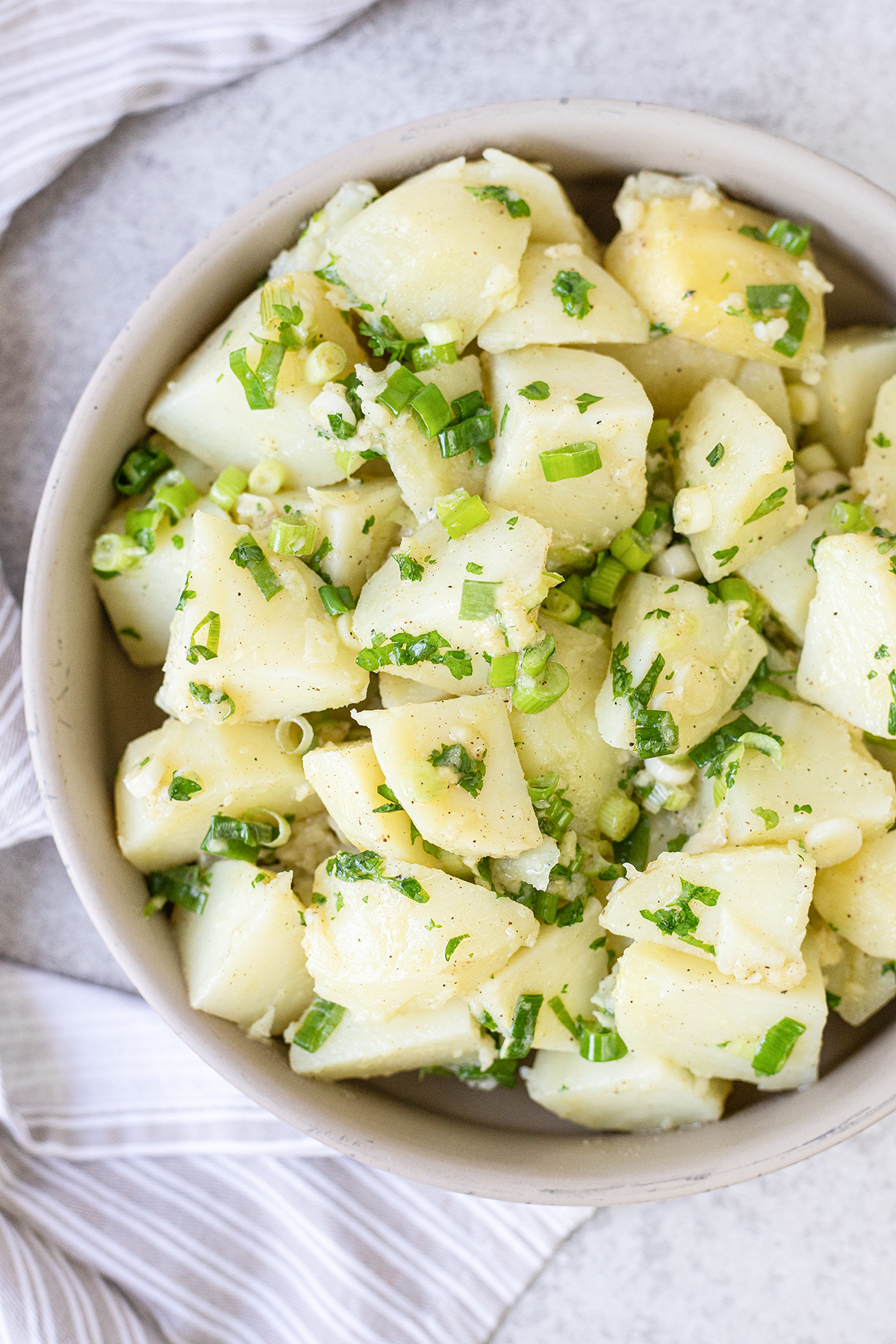 no mayo potato salad topped with spring onion.