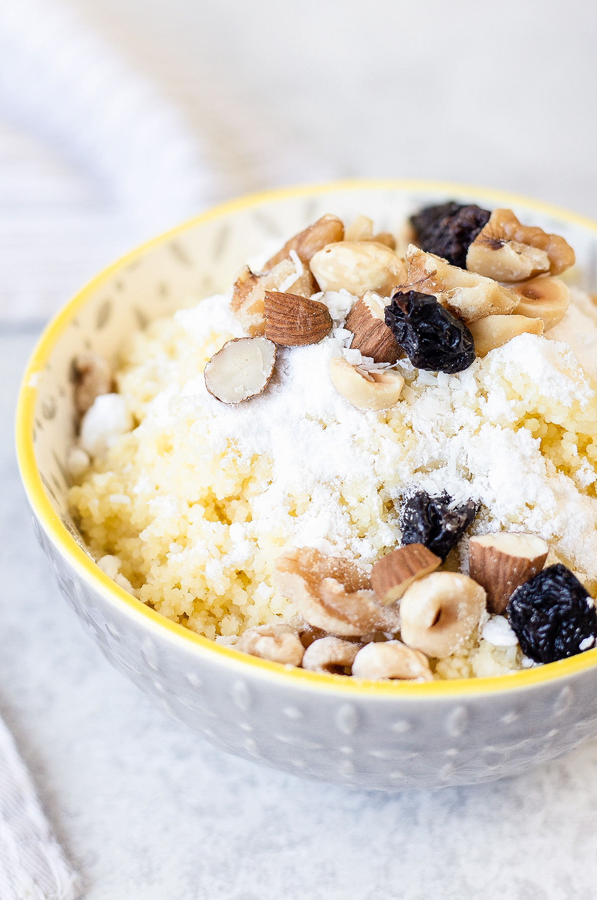 Sweet Couscous with butter, nuts, and powdered sugar