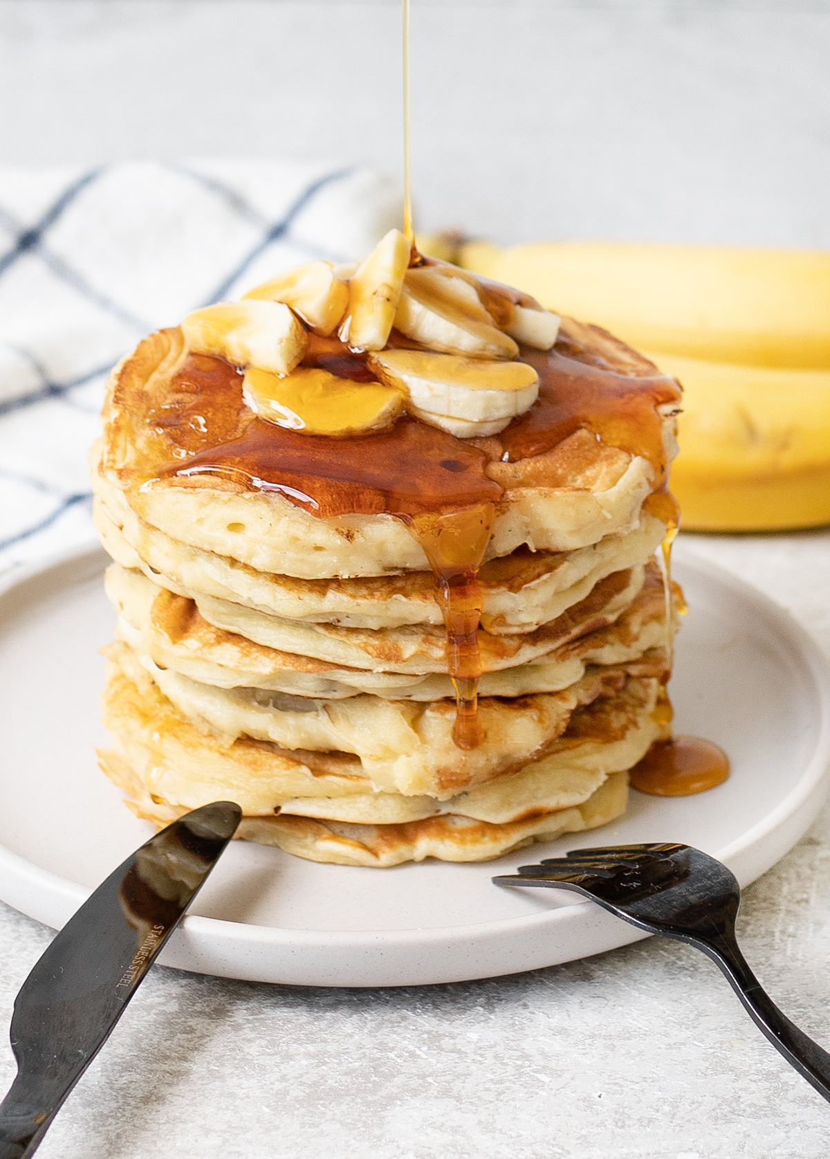 Pouring maple syrup over the pancakes