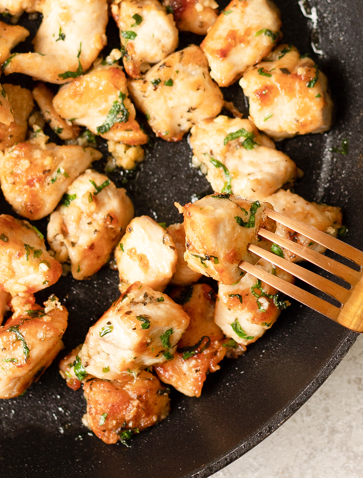 fork in the Garlic Butter Chicken Bites pan