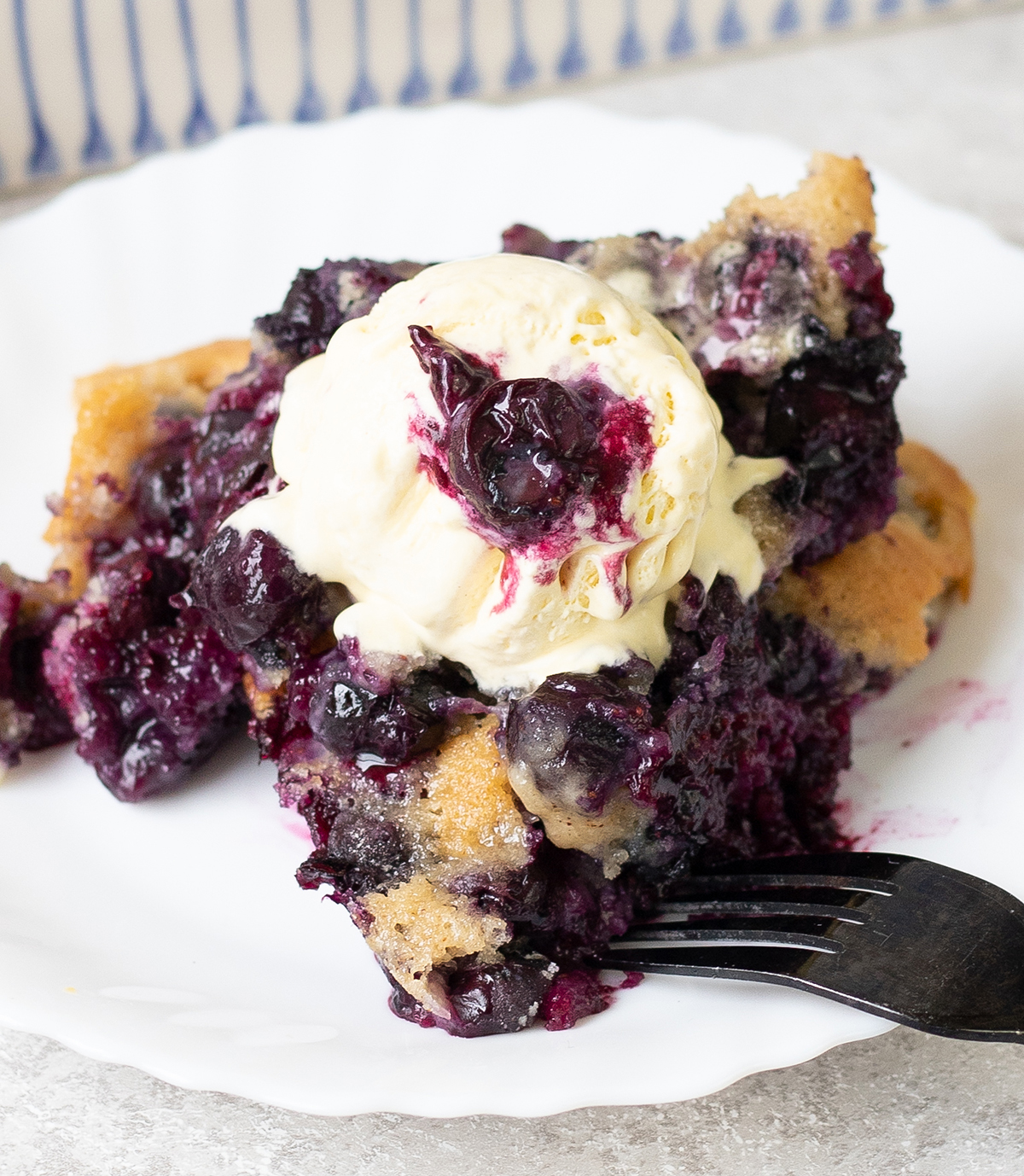 Blueberry Cobbler topped with vanilla ice cream.