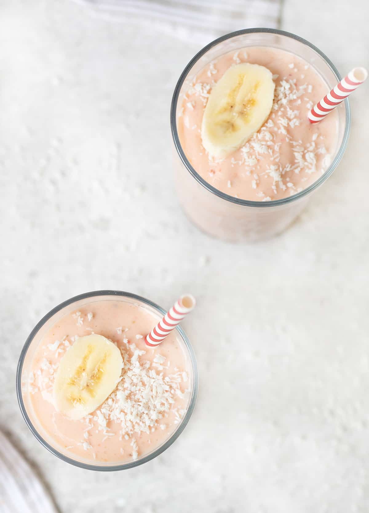 2 cups of the healthy Yogurt Smoothies topped with fresh banana slice.