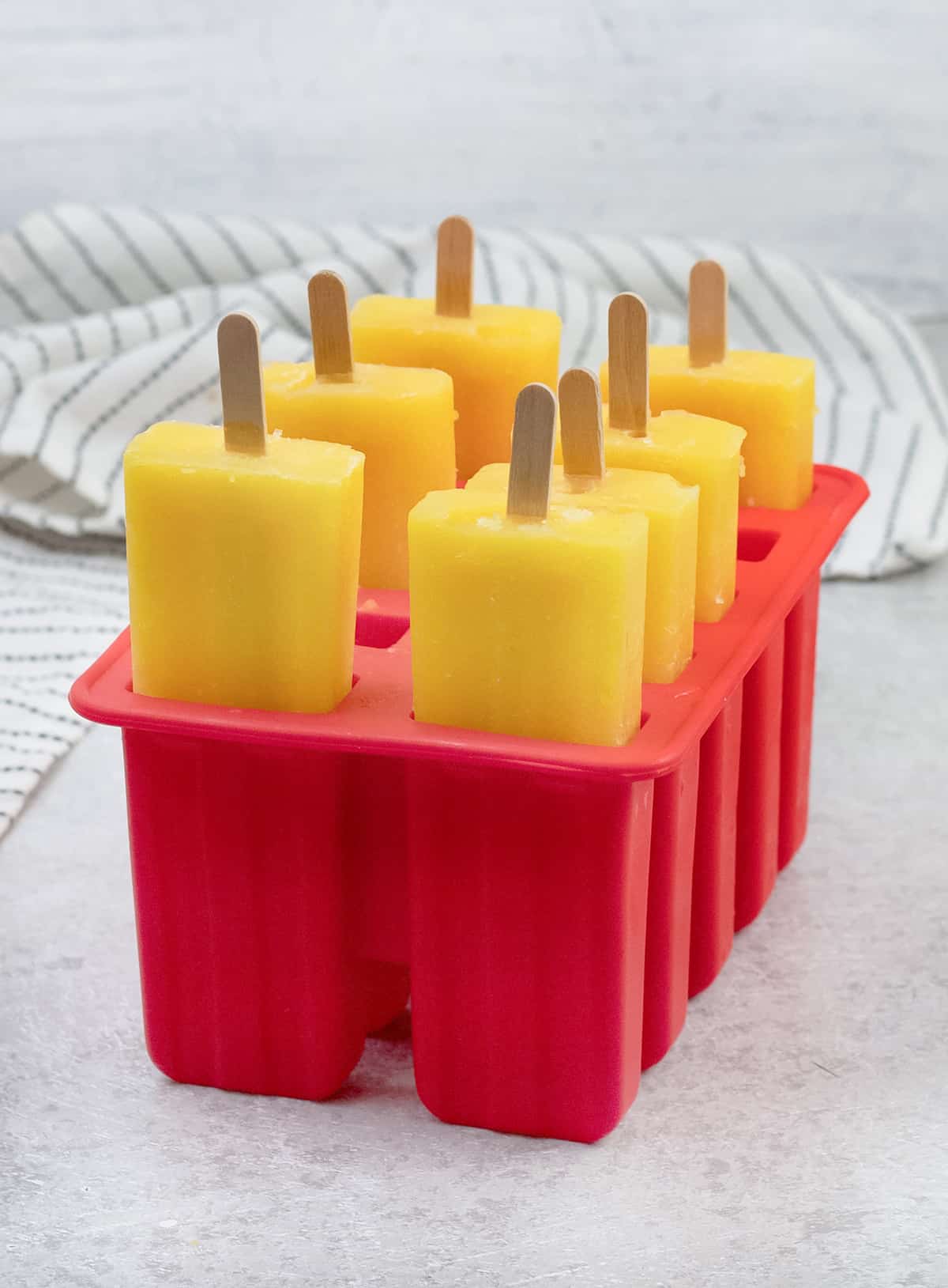 Mango Popsicles in popsicle molds.
