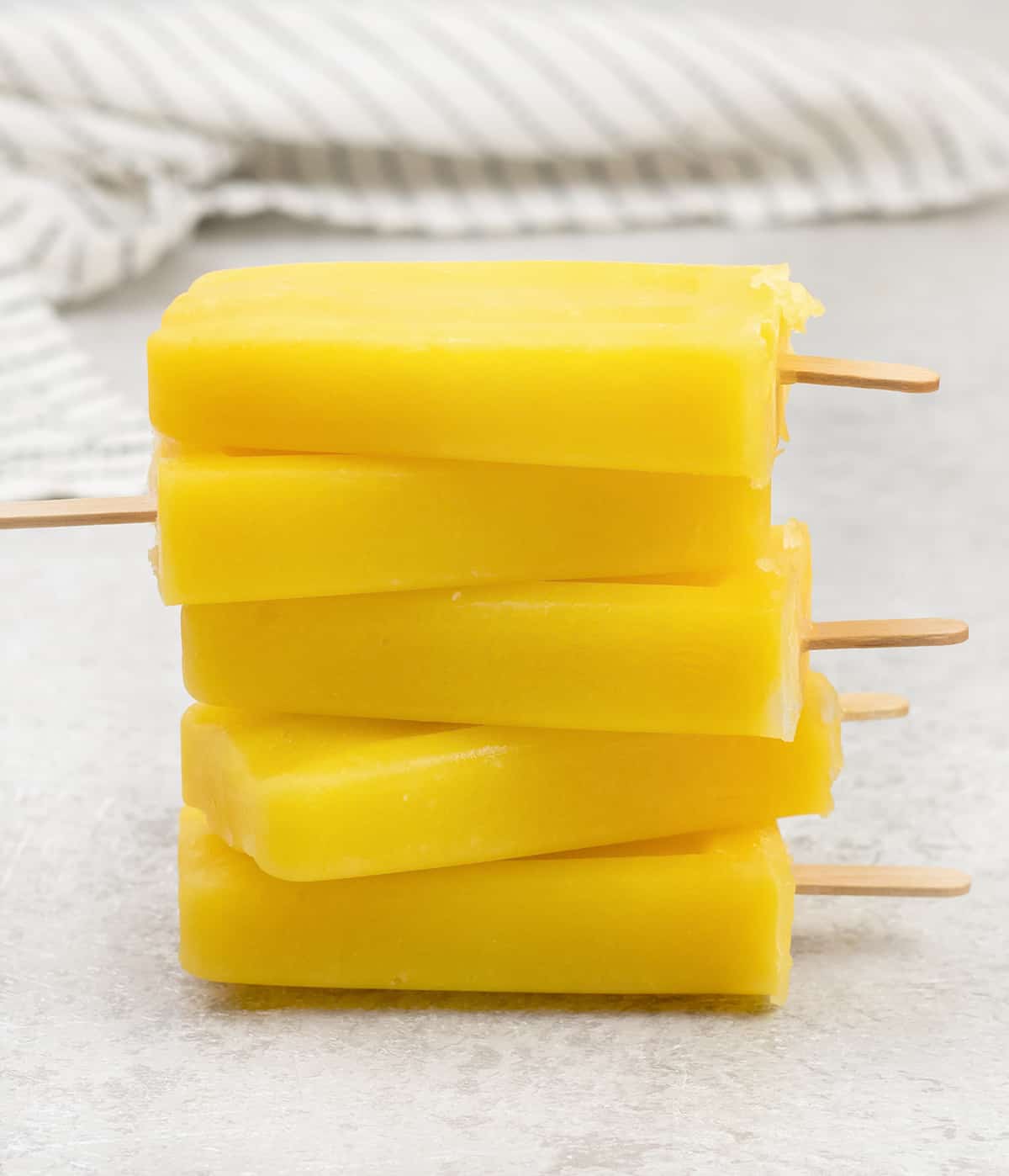 3 Ingredients Mango Popsicles on top of each others