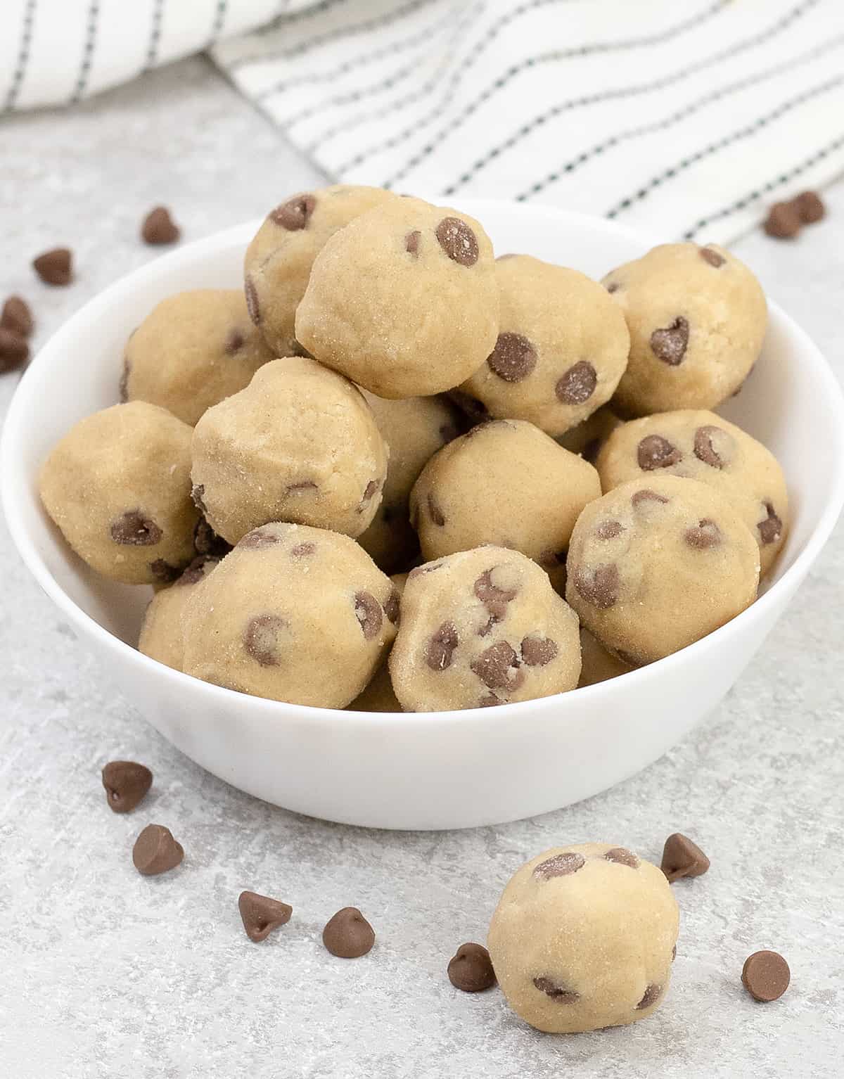 No Bake Cookie Dough Bites and some chocolate chips scattered around.