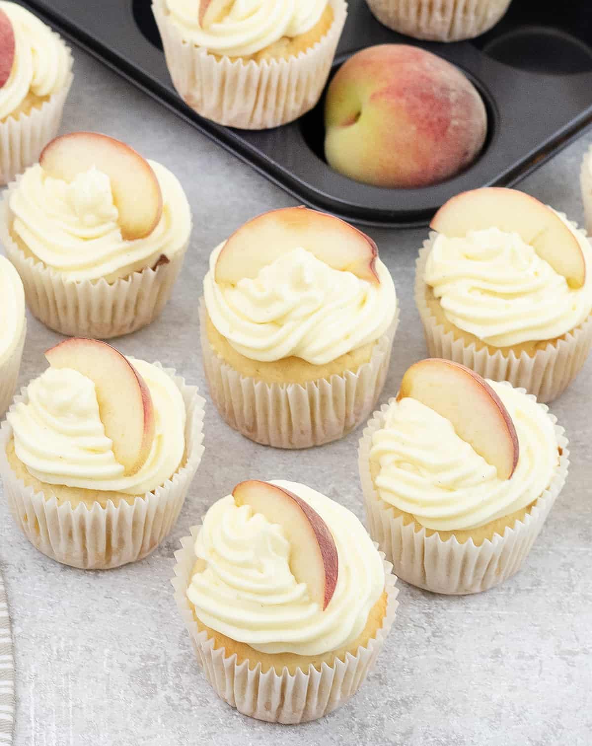 Peach Cupcakes topped wit a fresh peach slice