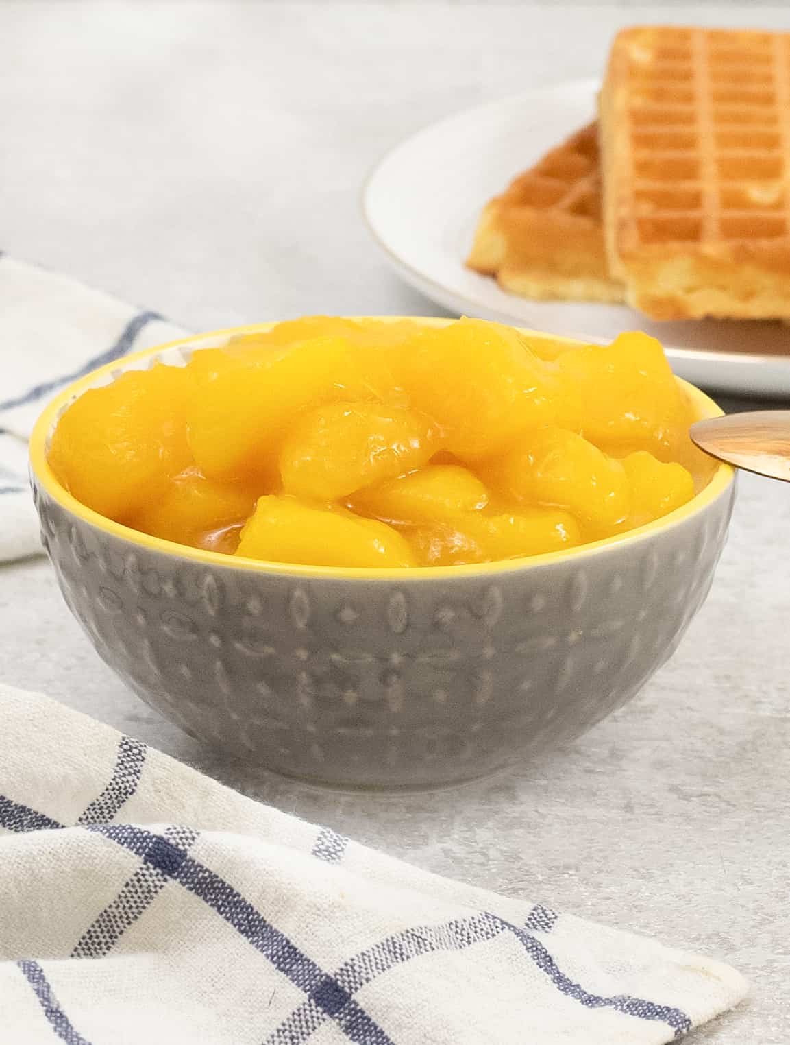 Mango Compote in a bowl and waffles