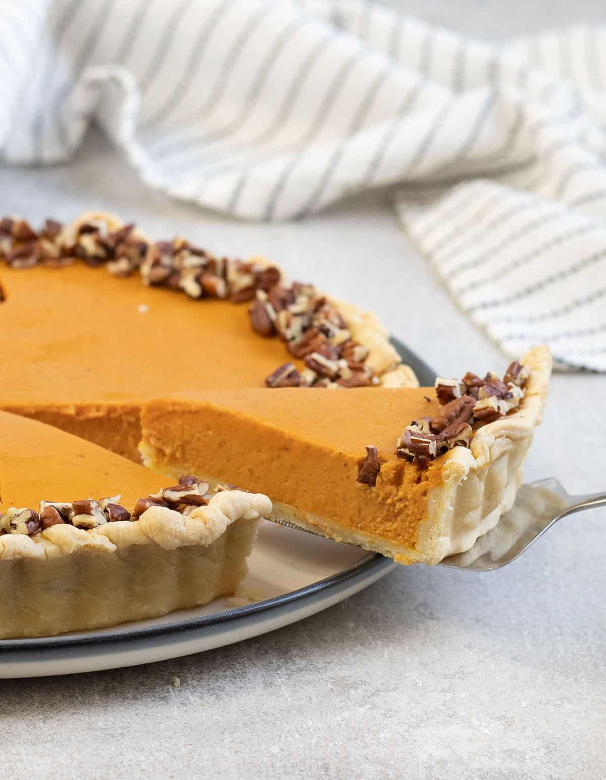 Cutting a slice from the pumpkin custard pie.