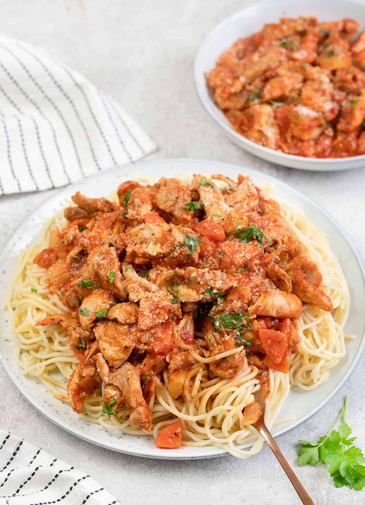 Chicken Bolognese on top of spaghetti.