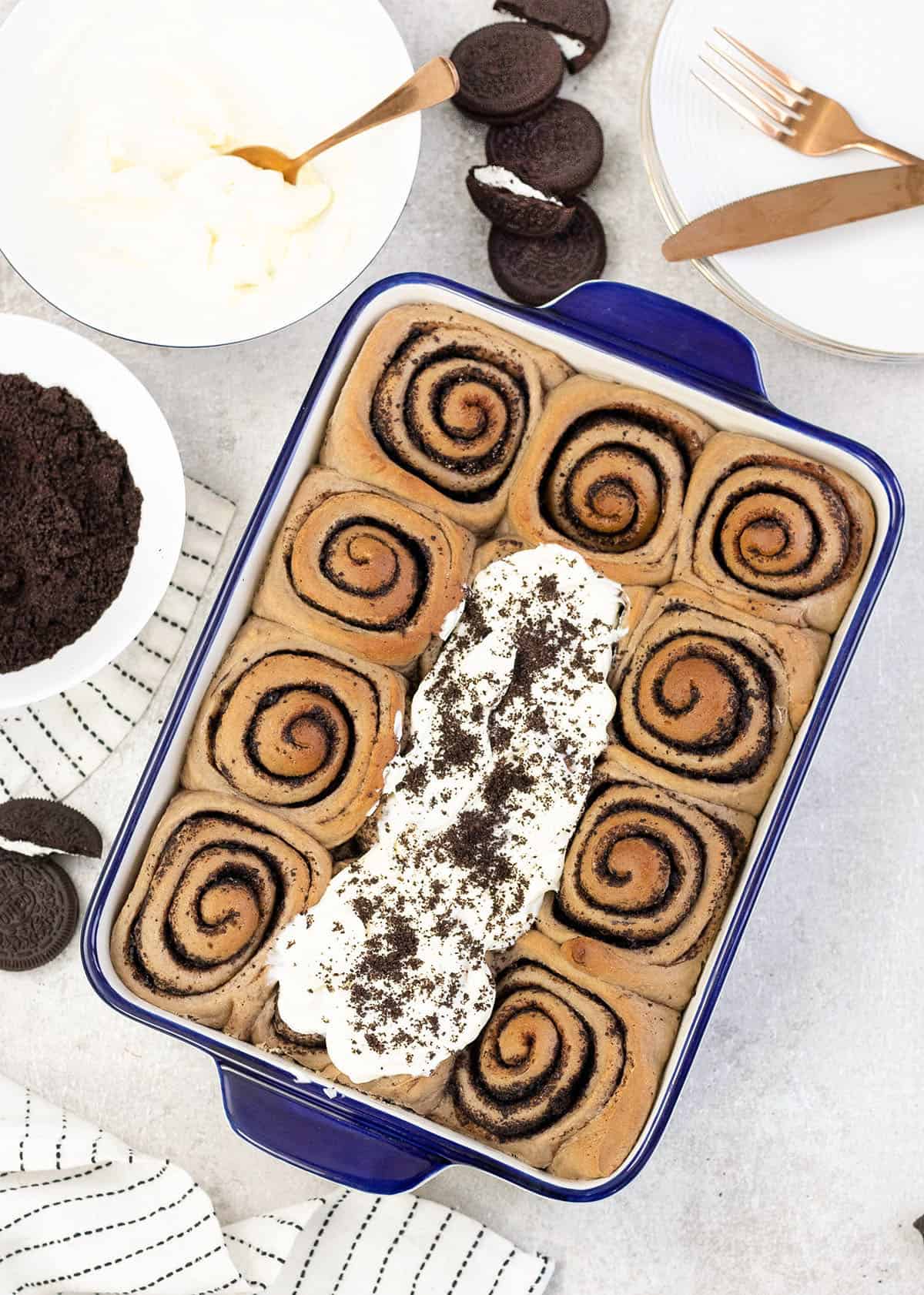 cookies and cream cinnamon rolls in a baking pan.