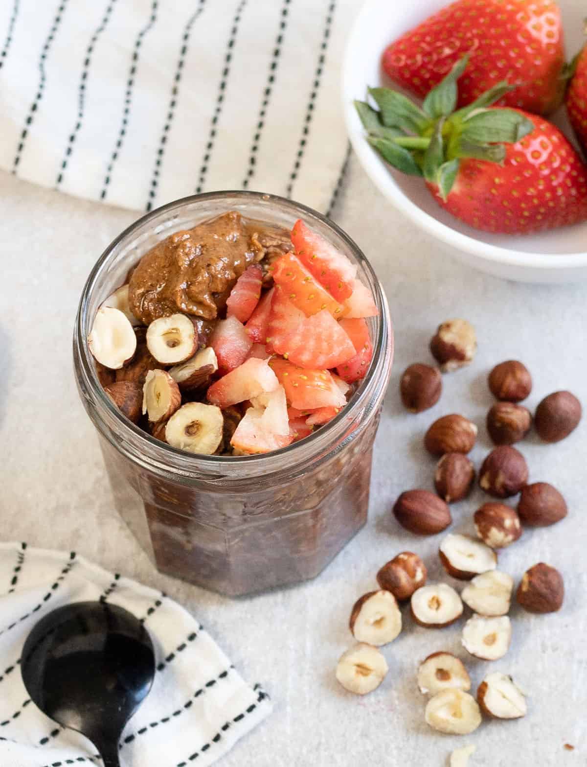 Nutella Overnight Oats topped with strawberries and hazelnuts