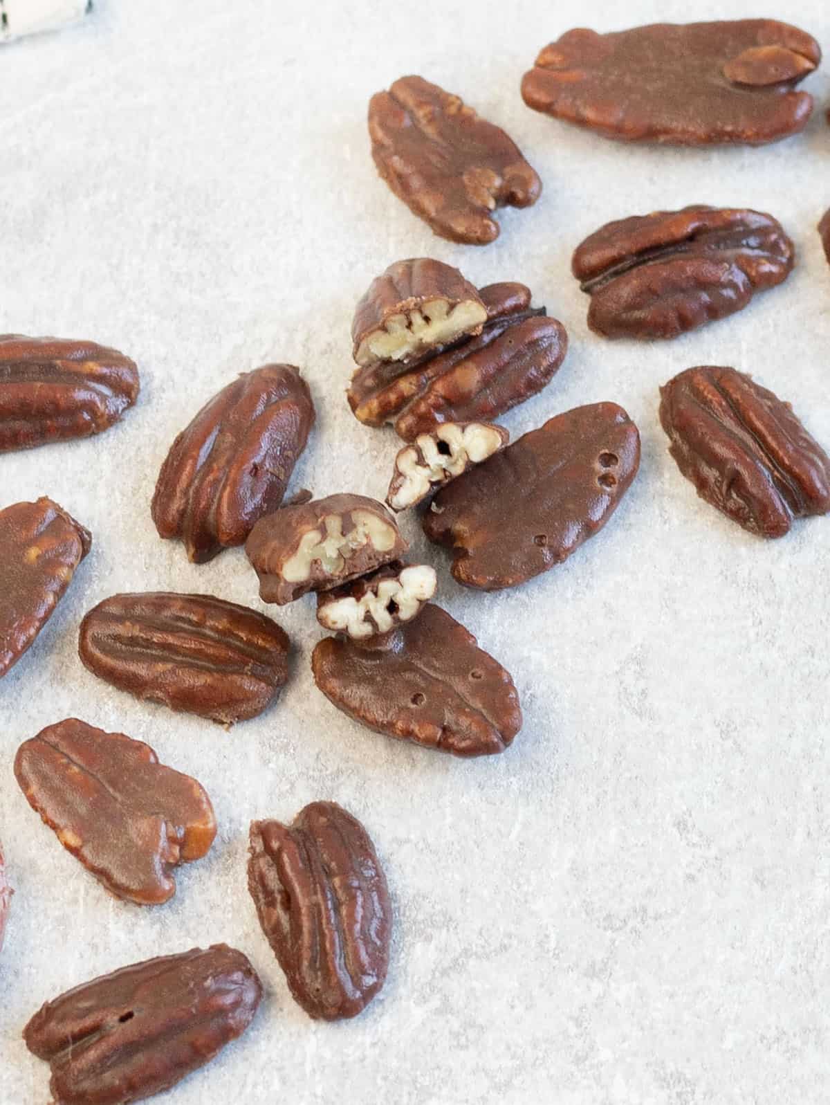 Chocolate Covered Pecans scattered on the table.