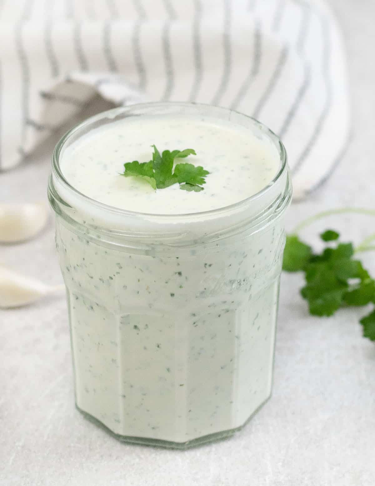 cilantro garlic sauce with lime in a jar.