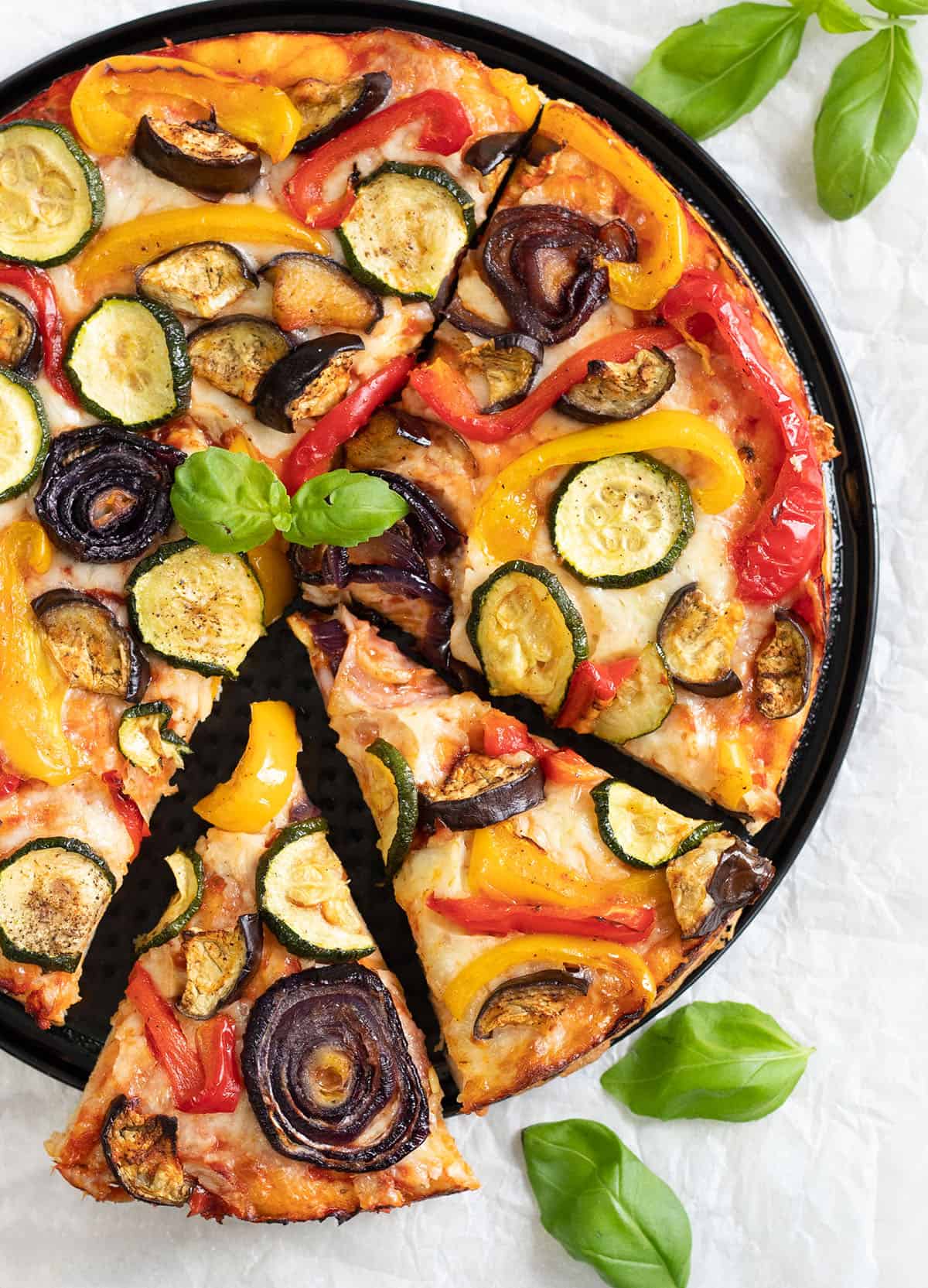 Roasted Vegetable Pizza topped with roasted veggies, cheese and pizza sauce.