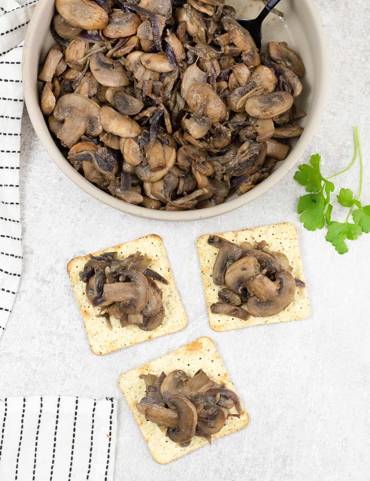 Caramelized mushrooms and onions on some crackers.