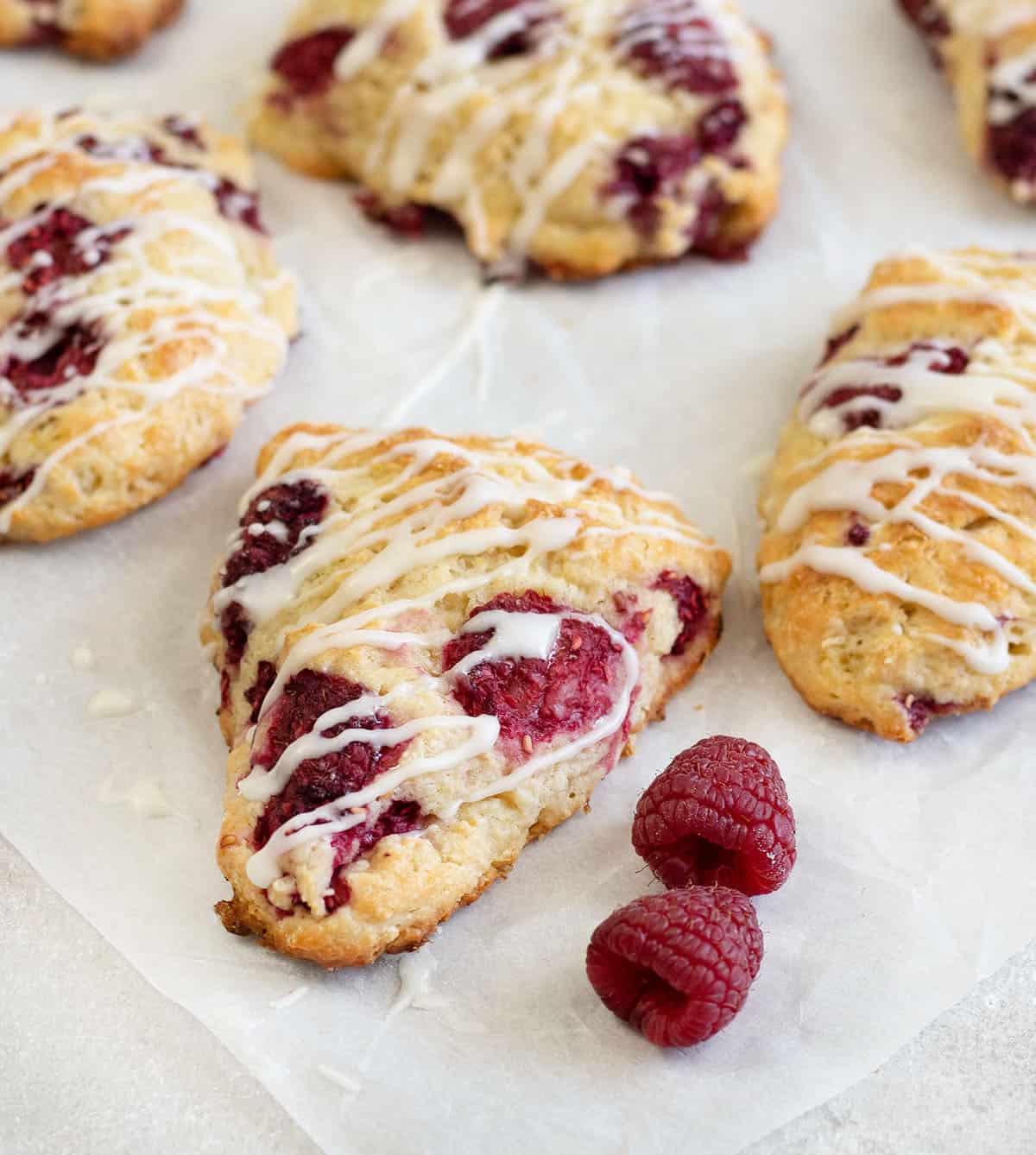 Lemon raspberry scones along with some fresh raspberries.