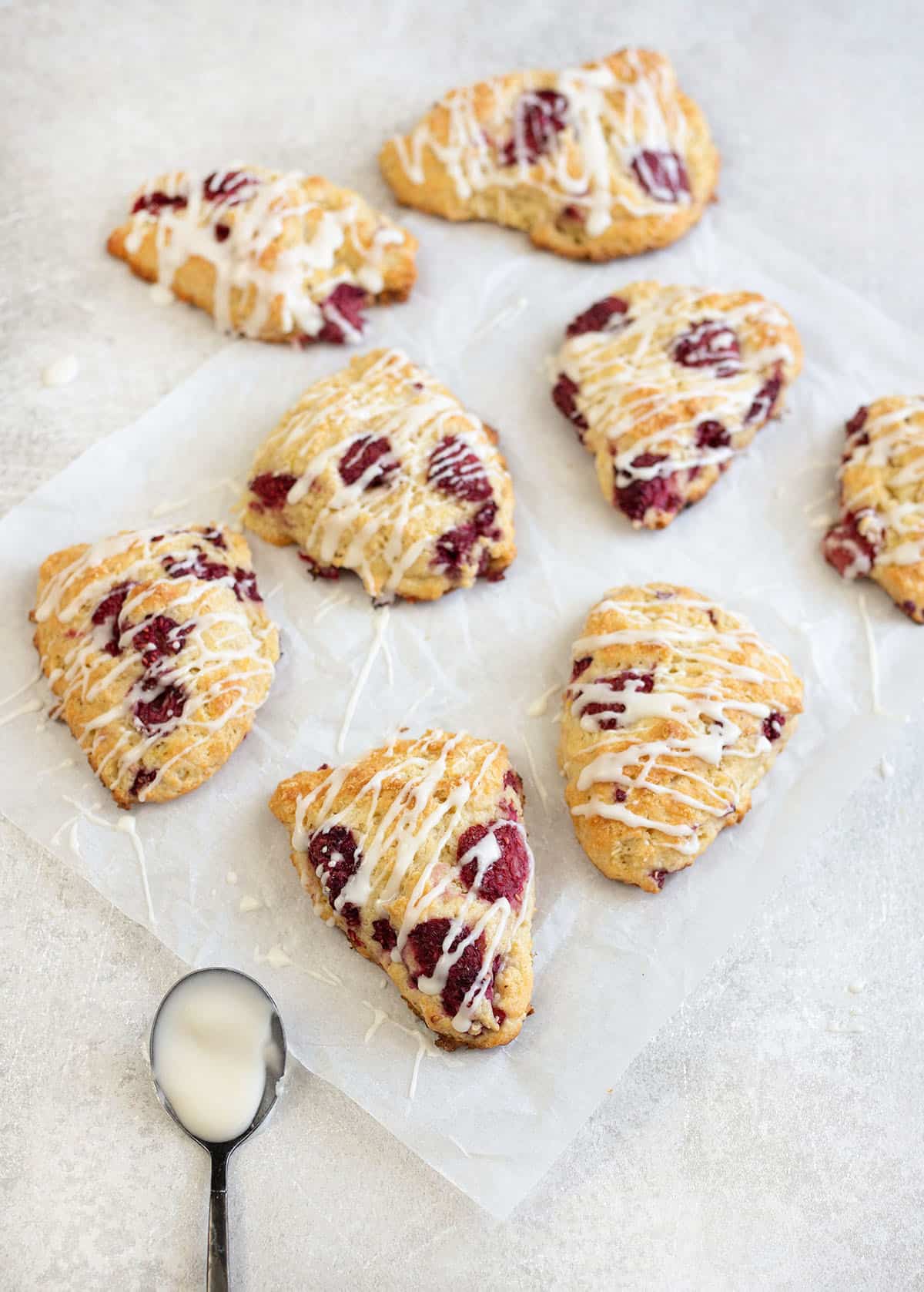 Lemon raspberry scones topped with lemon sugar glaze.