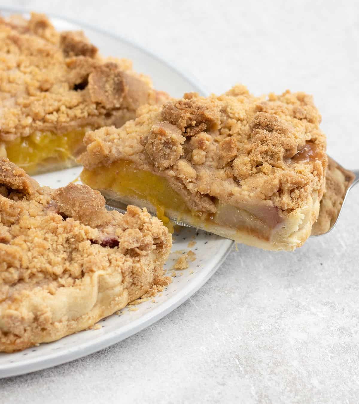 Cut a slice of the peach mango pie.