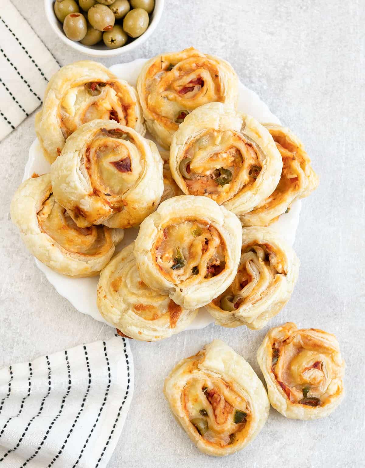Puff pastry pizza rolls in a plate.
