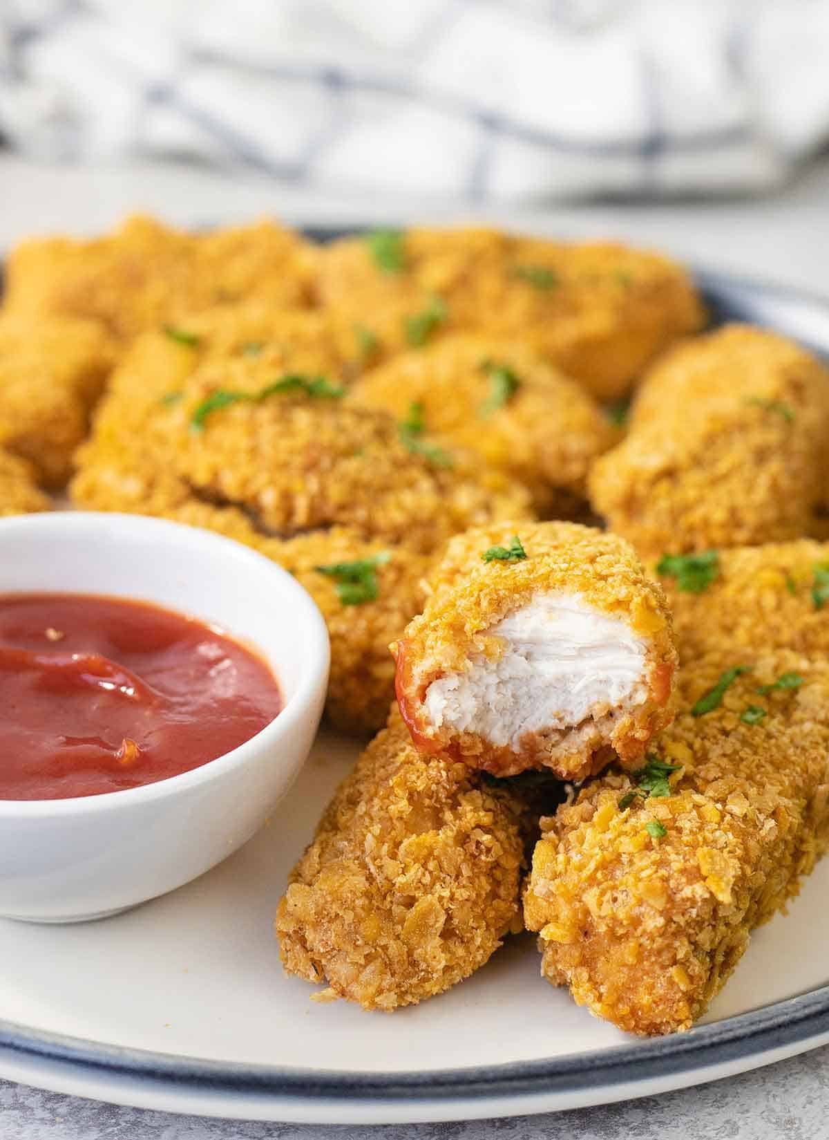 baked cornflake chicken nuggets in a big plate