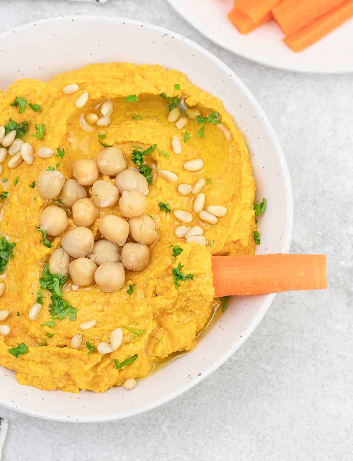 Sriracha carrot Hummus in a bowl.