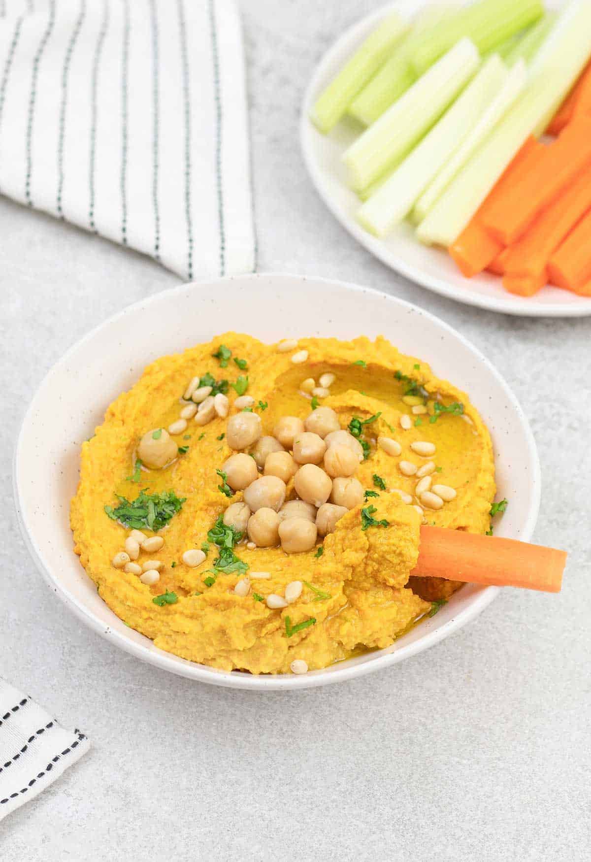 carrot dipped in Hummus.