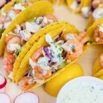 shrimp tacos topped with sour cream sauce