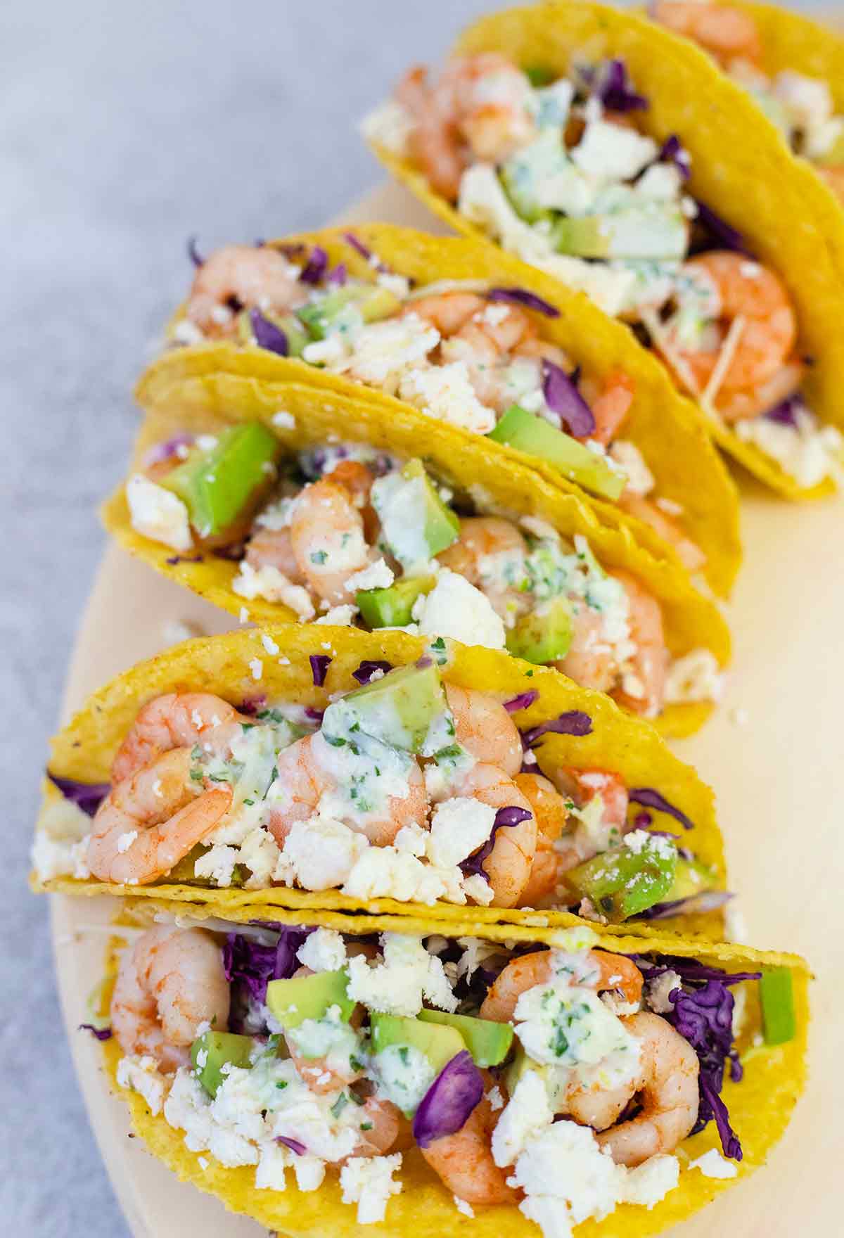 Mexican shrimp tacos topped with sour cream sauce.