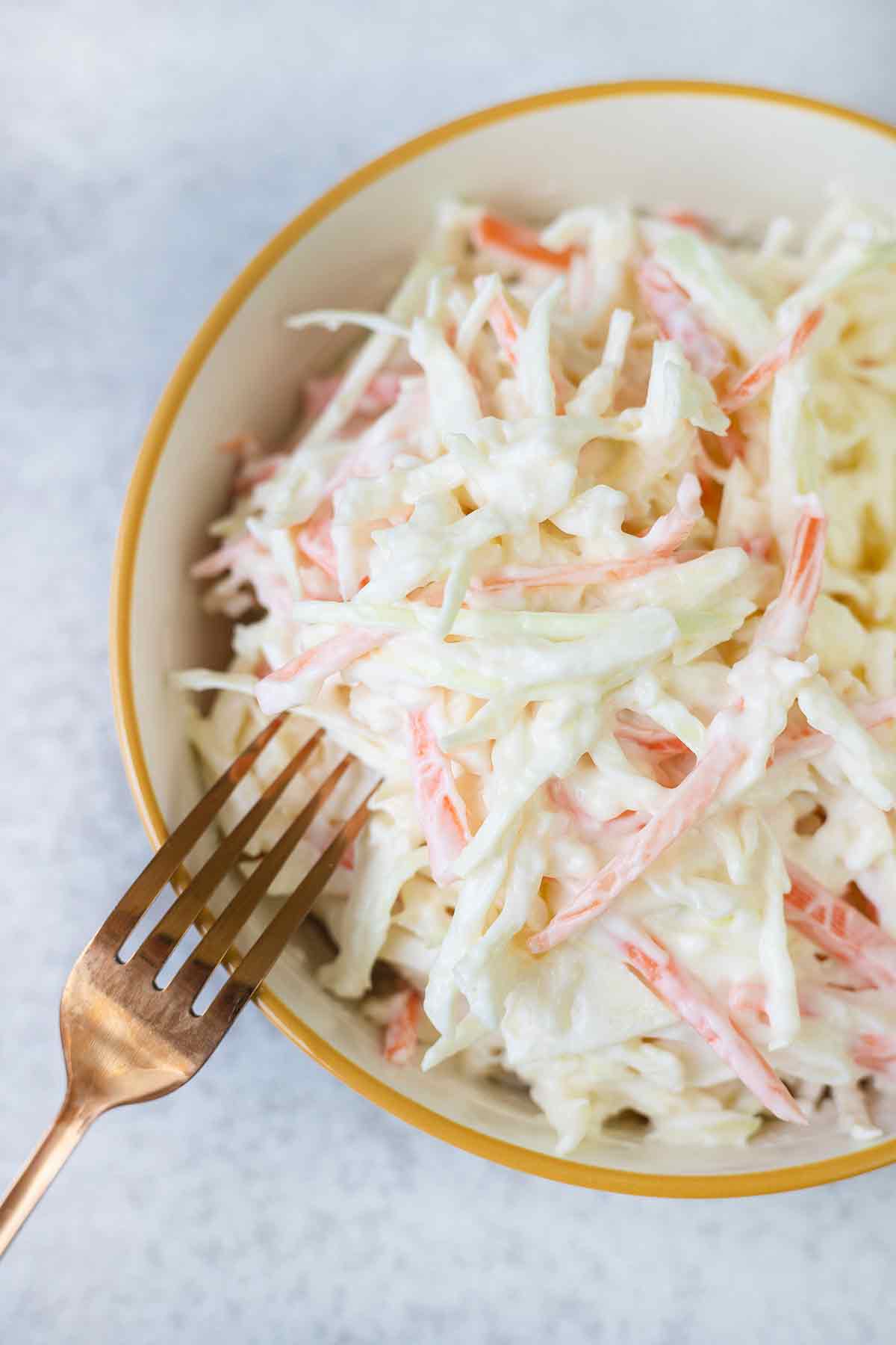 a fork is in the bowl of Coleslaw Salad