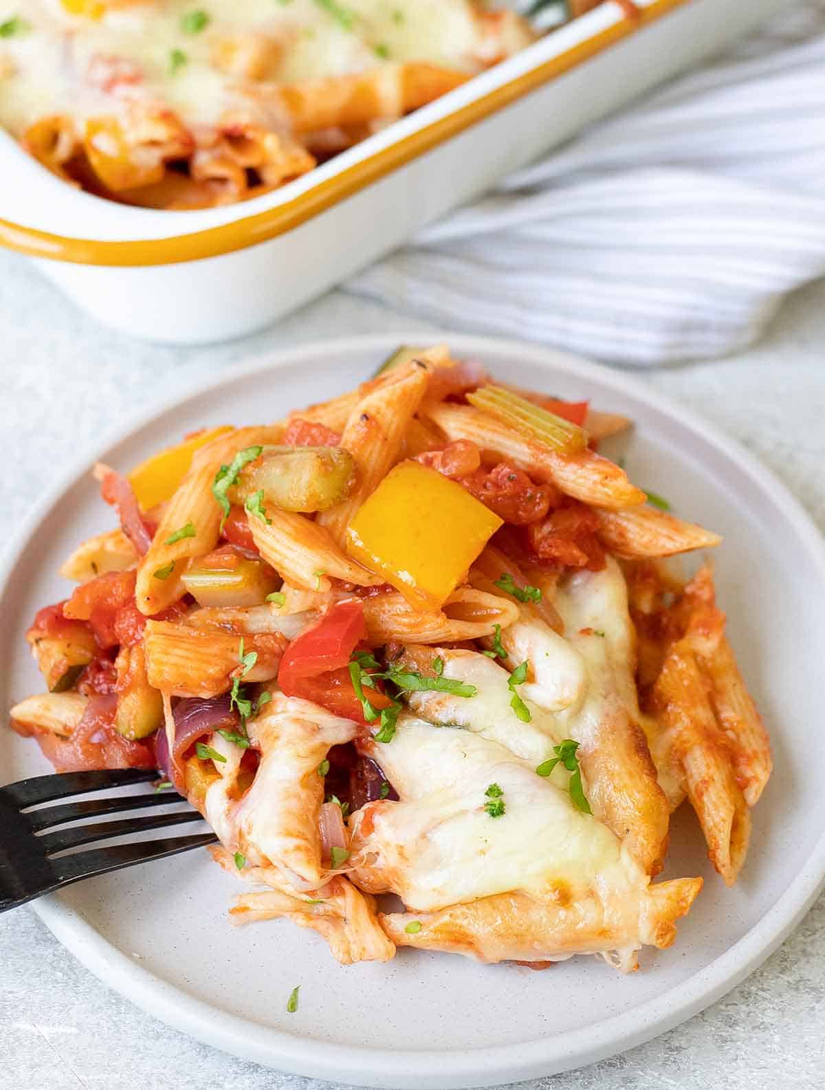 a plate of baked pasta and veggies