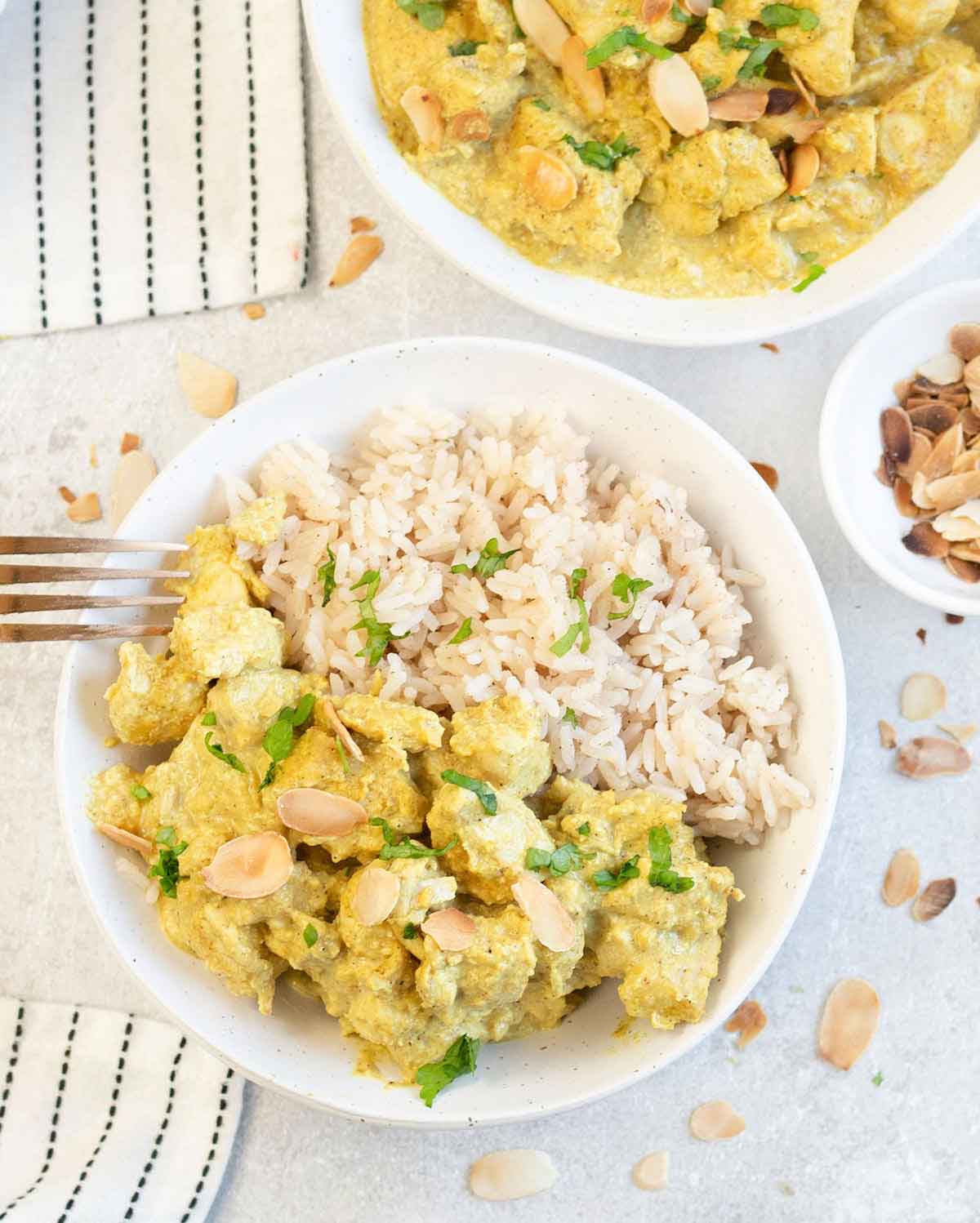 a plate full of Chicken Pasanda on top of rice.