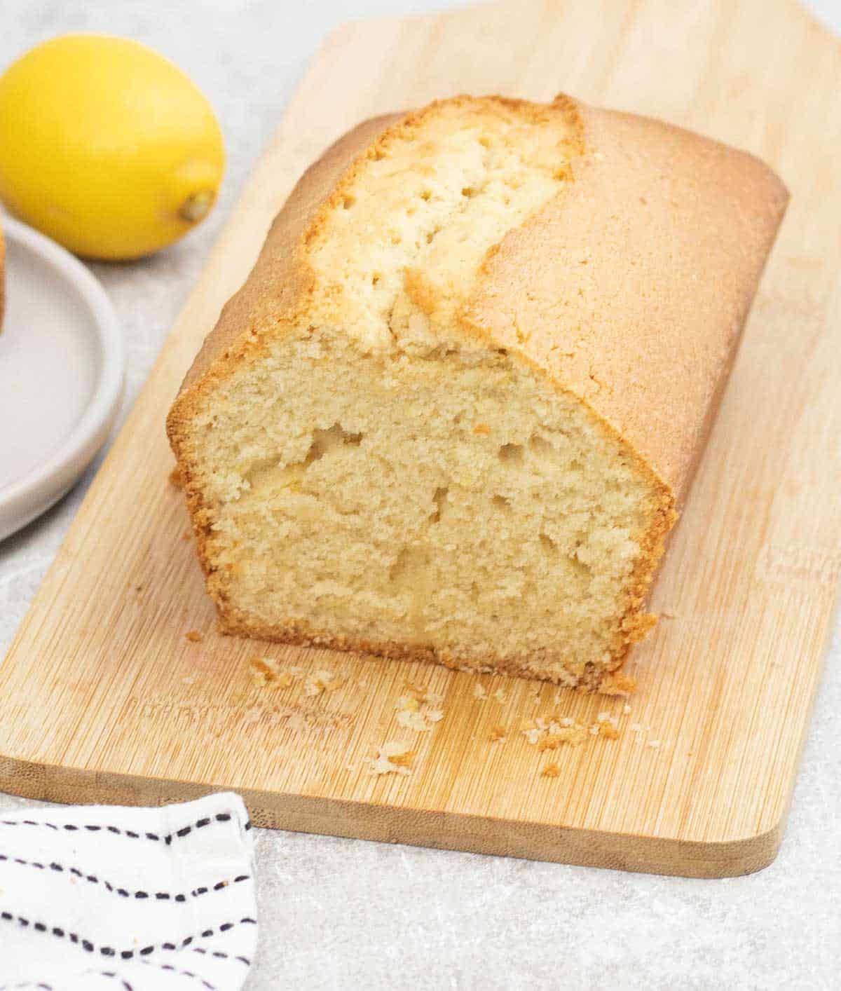 Madeira Cake on a chopping board and lemon on the background