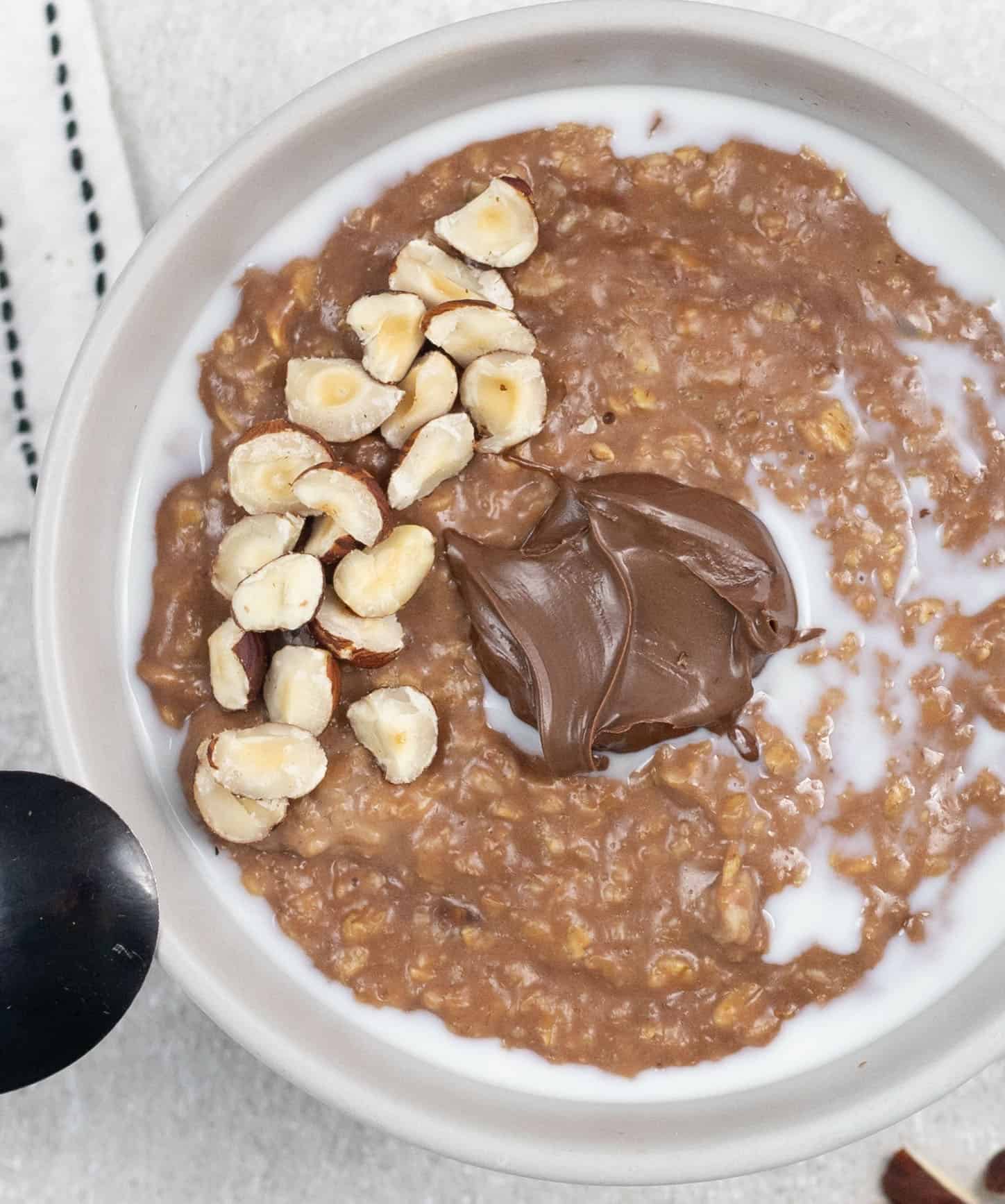 Nutella Porridge in a bowl topped with hazelnut 