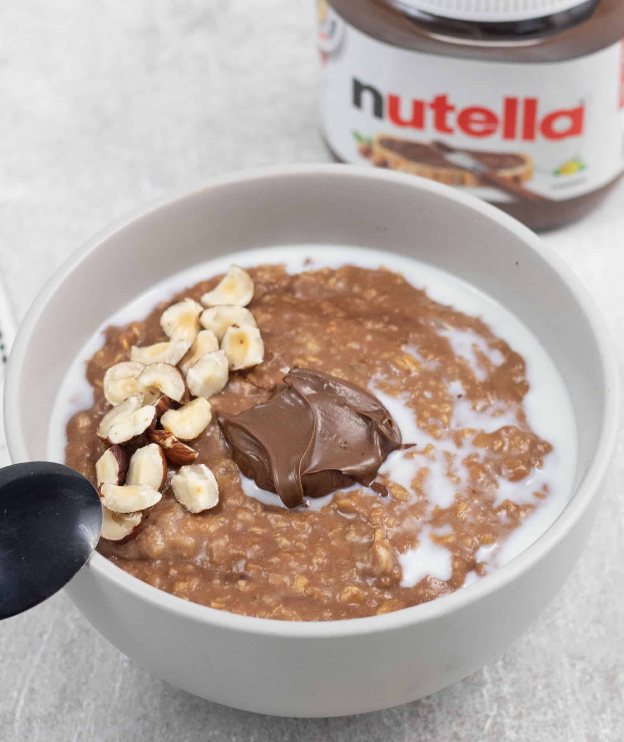 Nutella Porridge in a bowl in the background a Nutella jar