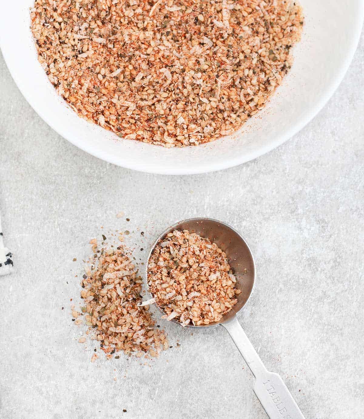 a measuring spoon filled with Salad Seasoning Mix.