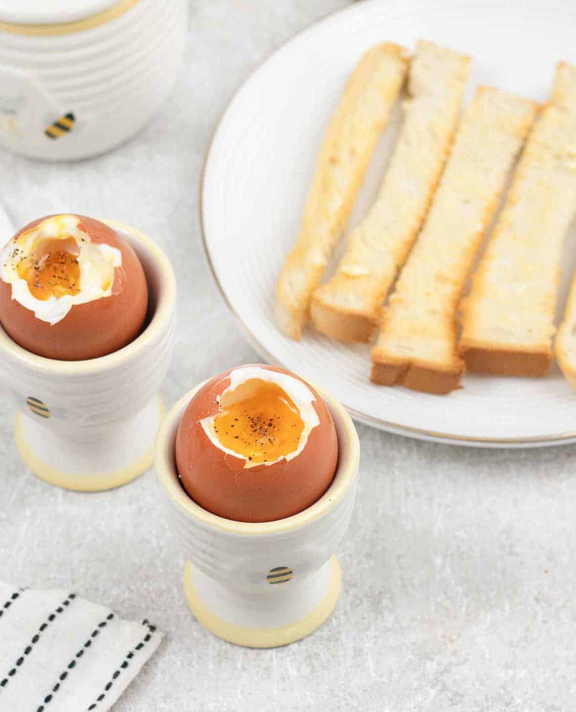 2 Dippy Eggs in egg cups with soldiers.
