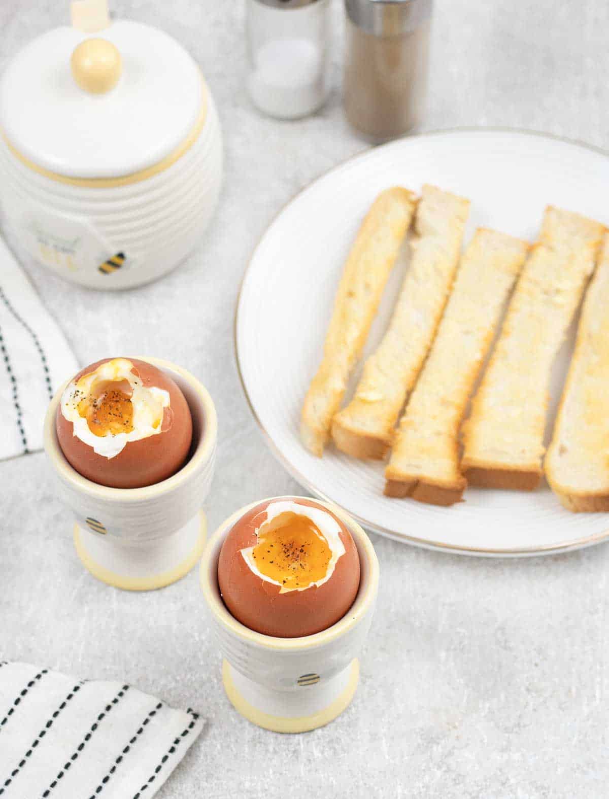 2 Dippy Eggs in egg cups with soldiers.