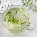 Thyme Tea with fresh Thyme sprig in the background