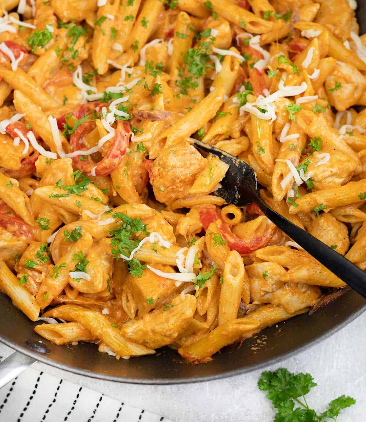 BBQ Chicken Pasta topped with Parsley in a pan.