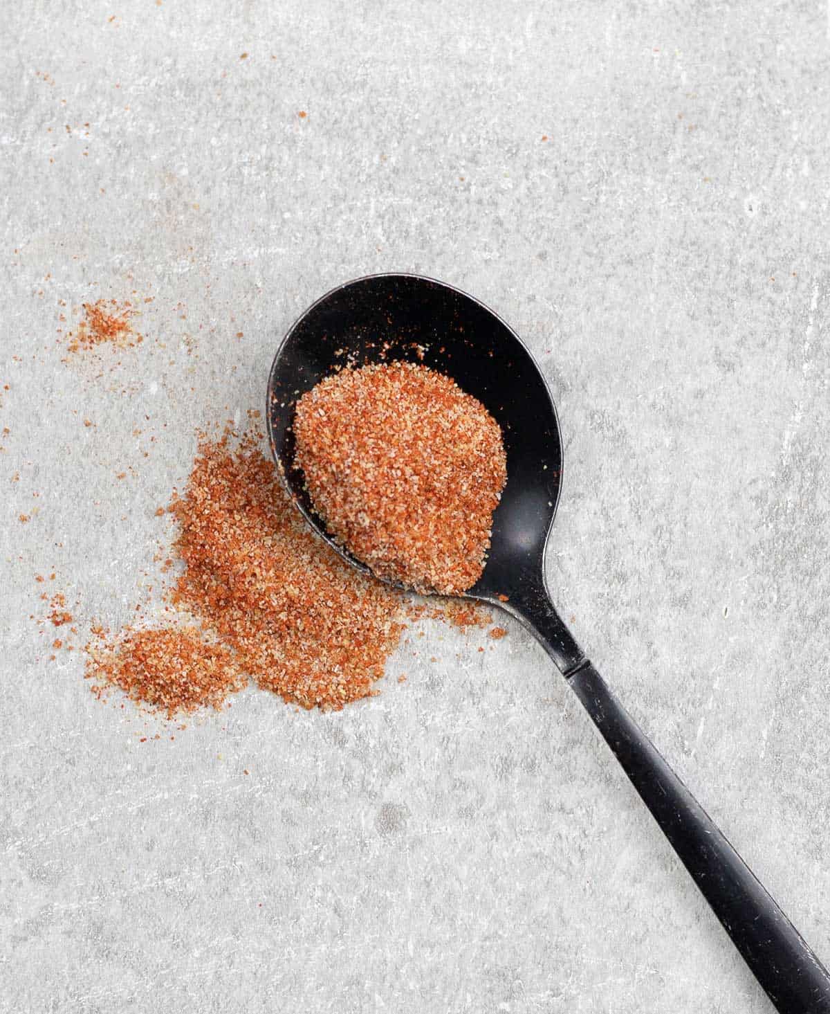 Enchilada Seasoning Mix sprinkled on the table.